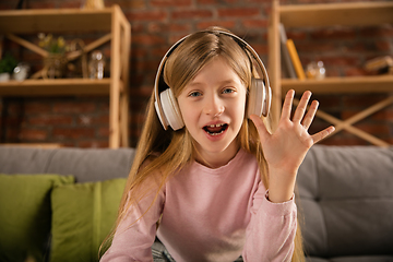 Image showing Little girl wearing headphones during online education course, lesson, view of screen