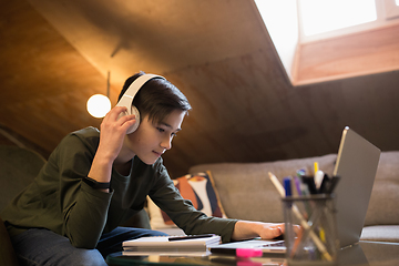 Image showing Little boy studying by group video call, use video conference with teacher, listening to online course