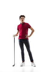 Image showing Golf player in a red shirt training, practicing isolated on white studio background