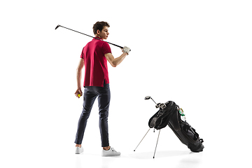 Image showing Golf player in a red shirt training, practicing isolated on white studio background