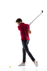 Image showing Golf player in a red shirt taking a swing isolated on white studio background