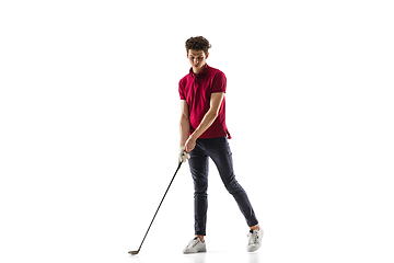 Image showing Golf player in a red shirt training, practicing isolated on white studio background