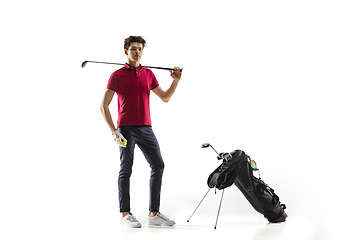 Image showing Golf player in a red shirt training, practicing isolated on white studio background