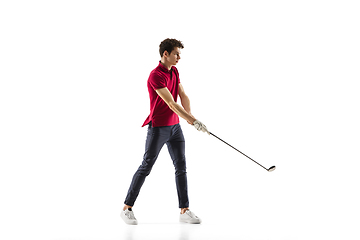 Image showing Golf player in a red shirt taking a swing isolated on white studio background