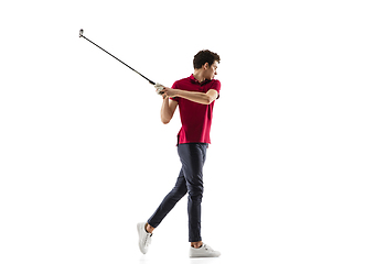 Image showing Golf player in a red shirt taking a swing isolated on white studio background