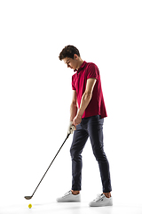 Image showing Golf player in a red shirt training, practicing isolated on white studio background