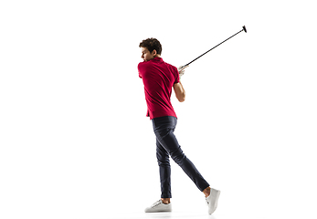 Image showing Golf player in a red shirt taking a swing isolated on white studio background