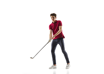 Image showing Golf player in a red shirt training, practicing isolated on white studio background