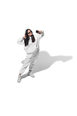 Image showing High angle view of young woman on white studio background. Girl in motion or movement. Human emotions and facial expressions concept