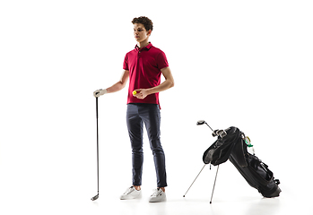 Image showing Golf player in a red shirt training, practicing isolated on white studio background