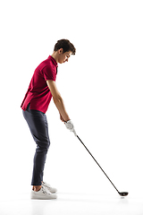 Image showing Golf player in a red shirt training, practicing isolated on white studio background