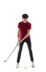 Image showing Golf player in a red shirt taking a swing isolated on white studio background