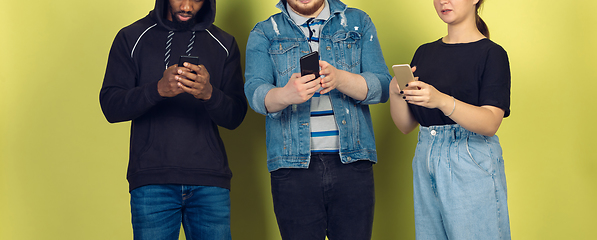 Image showing Group of friends using mobile smartphones. Teenagers addiction to new technology trends. Close up.