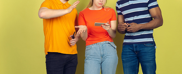 Image showing Group of friends using mobile smartphones. Teenagers addiction to new technology trends. Close up.