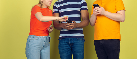 Image showing Group of friends using mobile smartphones. Teenagers addiction to new technology trends. Close up.