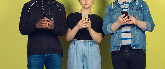 Image showing Group of friends using mobile smartphones. Teenagers addiction to new technology trends. Close up.