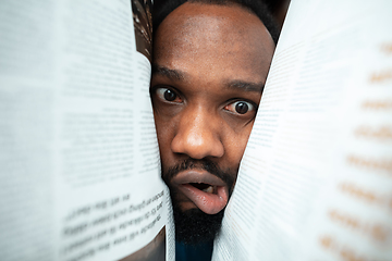 Image showing African-american man looking for job in unusual places at his home