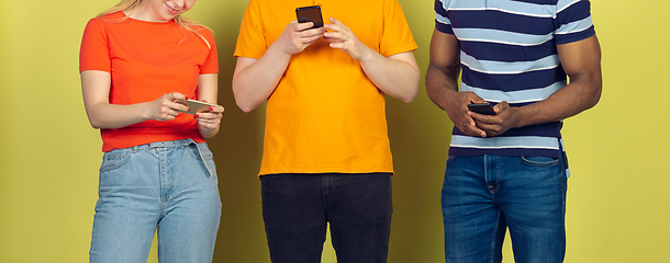 Image showing Group of friends using mobile smartphones. Teenagers addiction to new technology trends. Close up.