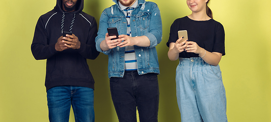 Image showing Group of friends using mobile smartphones. Teenagers addiction to new technology trends. Close up.