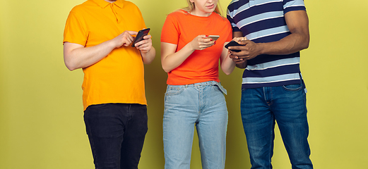 Image showing Group of friends using mobile smartphones. Teenagers addiction to new technology trends. Close up.