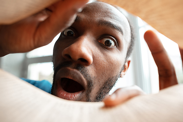 Image showing African-american man looking for job in unusual places at his home