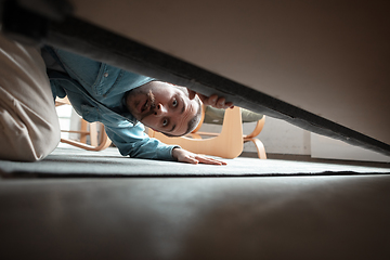 Image showing Caucasian man looking for job in unusual places at his home