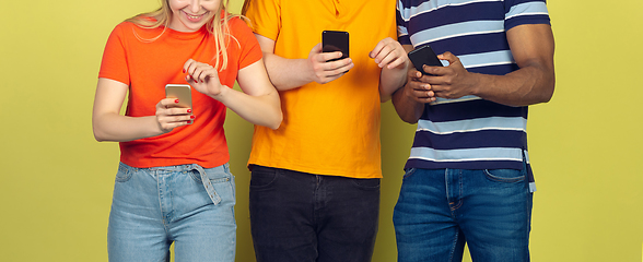 Image showing Group of friends using mobile smartphones. Teenagers addiction to new technology trends. Close up.