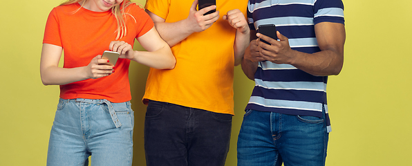 Image showing Group of friends using mobile smartphones. Teenagers addiction to new technology trends. Close up.