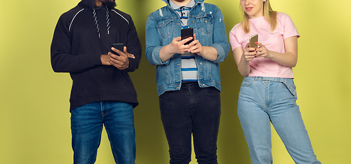 Image showing Group of friends using mobile smartphones. Teenagers addiction to new technology trends. Close up.