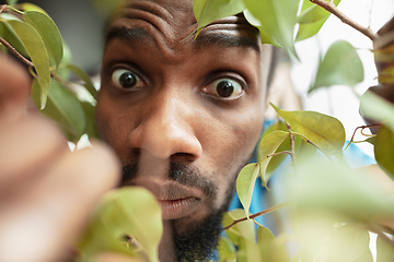 Image showing African-american man looking for job in unusual places at his home