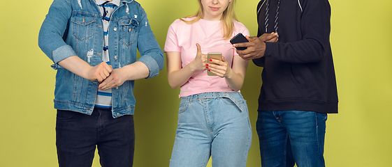 Image showing Group of friends using mobile smartphones. Teenagers addiction to new technology trends. Close up.