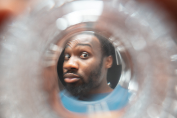 Image showing African-american man looking for job in unusual places at his home