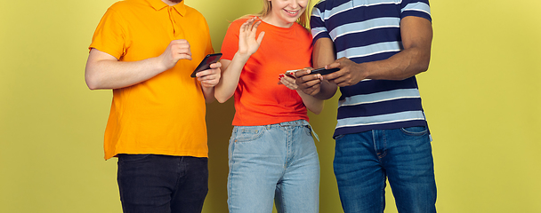 Image showing Group of friends using mobile smartphones. Teenagers addiction to new technology trends. Close up.