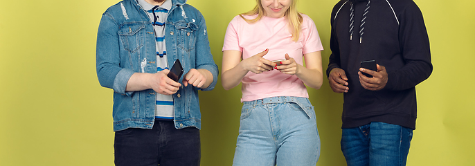 Image showing Group of friends using mobile smartphones. Teenagers addiction to new technology trends. Close up.