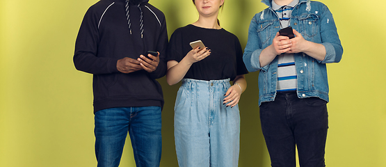 Image showing Group of friends using mobile smartphones. Teenagers addiction to new technology trends. Close up.