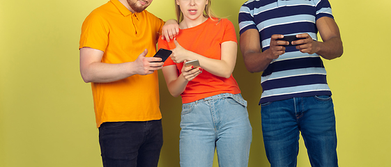 Image showing Group of friends using mobile smartphones. Teenagers addiction to new technology trends. Close up.