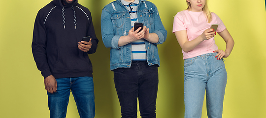 Image showing Group of friends using mobile smartphones. Teenagers addiction to new technology trends. Close up.