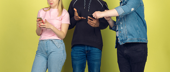 Image showing Group of friends using mobile smartphones. Teenagers addiction to new technology trends. Close up.