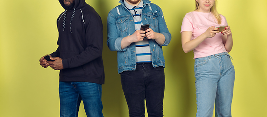 Image showing Group of friends using mobile smartphones. Teenagers addiction to new technology trends. Close up.