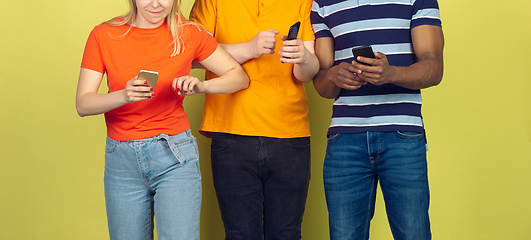 Image showing Group of friends using mobile smartphones. Teenagers addiction to new technology trends. Close up.