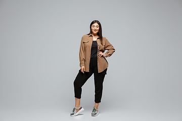 Image showing Young caucasian woman in casual wear. Bodypositive female character, plus size businesswoman