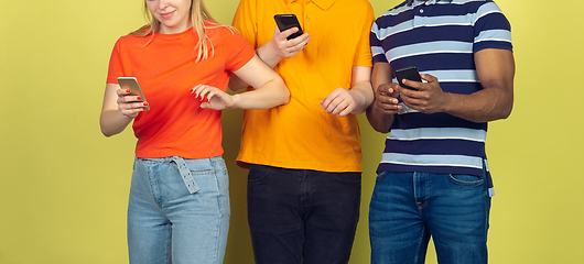 Image showing Group of friends using mobile smartphones. Teenagers addiction to new technology trends. Close up.