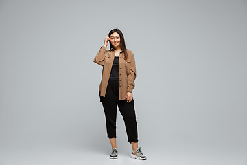 Image showing Young caucasian woman in casual wear. Bodypositive female character, plus size businesswoman