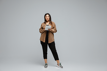 Image showing Young caucasian woman in casual wear. Bodypositive female character, plus size businesswoman