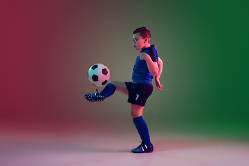 Image showing Teen male football or soccer player, boy on gradient background in neon light - motion, action, activity concept