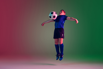 Image showing Teen male football or soccer player, boy on gradient background in neon light - motion, action, activity concept