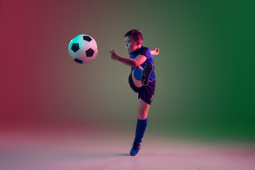 Image showing Teen male football or soccer player, boy on gradient background in neon light - motion, action, activity concept