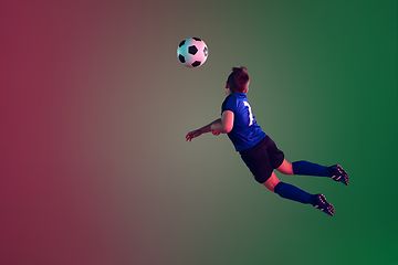 Image showing Teen male football or soccer player, boy on gradient background in neon light - motion, action, activity concept