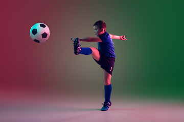 Image showing Teen male football or soccer player, boy on gradient background in neon light - motion, action, activity concept