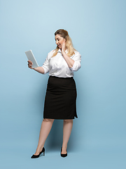 Image showing Young caucasian woman in office attire on blue background. Bodypositive female character. plus size businesswoman